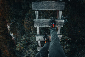 Feet walking in a wood bridge