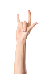 Hand of woman showing "devil horns" gesture on white background