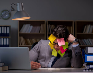 Businessman staying late to sort out priorities