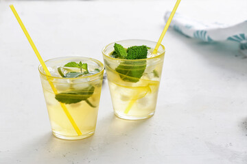 Cups of tasty cold ice tea on table