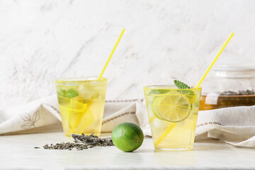 Cups of tasty cold ice tea on table