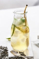 Bottle of tasty cold ice tea on table