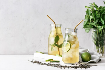 Bottles of tasty cold ice tea on table