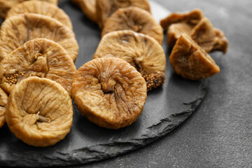 Tasty dried figs on dark background, closeup