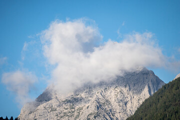 Fototapeta na wymiar peaks of the wetterstein mountains in the clouds in the early morning, view from mittenwald town