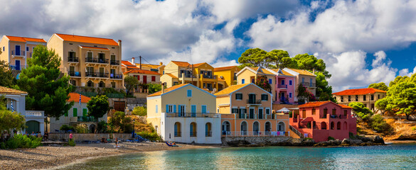 Fototapeta na wymiar Assos village in Kefalonia, Greece. Turquoise colored bay in Mediterranean sea with beautiful colorful houses in Assos village in Kefalonia, Greece, Ionian island, Cephalonia, Assos village.