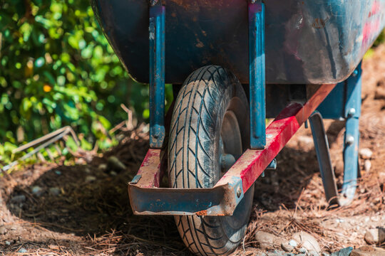 Closeup shot of the tire on a wheelbarrow in a yard