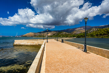 View of the De Bosset Bridge in Argostoli city on Kefalonia island. De Bosset Bridge on lakeside In Argostoli, Kefalonia. Obelisk and the de Bosset bridge in Argostoli, Kefalonia, Greece
