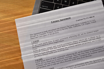 The "License Agreement" is placed on a laptop on my desk.