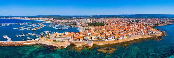 Aerial view over Alghero old town, cityscape Alghero view on a beautiful day with harbor and open sea in view. Alghero, Italy. Panoramic aerial view of Alghero, Sardinia, Italy.