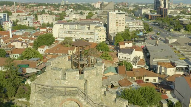 
Drone video of a mosque standing in the historic center where there are many narrow streets and houses with red roofs. Aerial view of Skopje Macedonia.