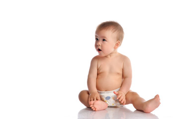 Little baby in nappy on floor stretching out by hand