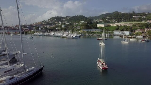 Traditional sloop boat sailing out the harbour, St. George's, Grenada