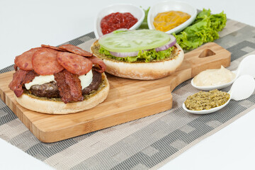 Slice Of Hamburger Bun With Salami, meat, And Sauce; Ready To Assemble The Burger.
