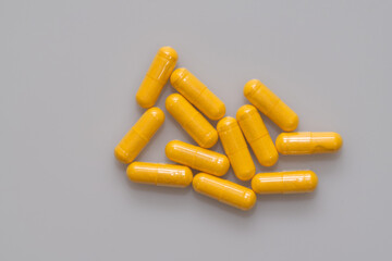 Curcumin powder vegetarian capsules on light background