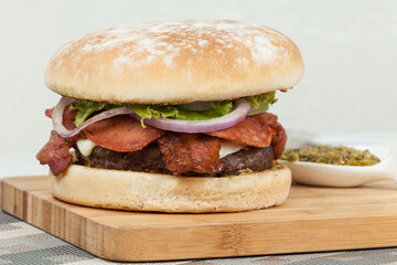 Tasty Italian Burger With Cheese, Meat, Bacon, And Slices Of Salami.