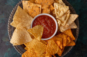 Snacks and chips with dip, salsa, ketchup and sauces, top view, snack for beer or big parties