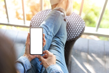 cell phone mockup blank white screen.woman hand holding texting using mobile on desk at coffee shop.background empty space for advertise.work people contact marketing business,technology