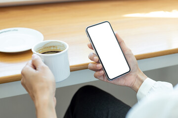 cell phone mockup blank white screen.woman hand holding texting using mobile on desk at coffee shop.background empty space for advertise.work people contact marketing business,technology