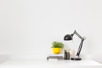 Home office desk with white wall copy space Mock up.	
