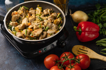 Roasting meat, pork with vegetables, on the background of fresh vegetables, cooking and cooking