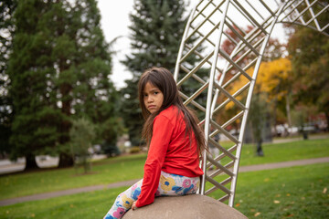 Naklejka premium little girl playing on the playground