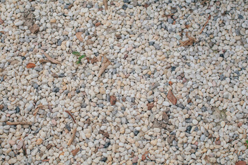 Abstract colorful mini granite crushed stones on ground texture background. Gray rubble construction rock pebble pattern.