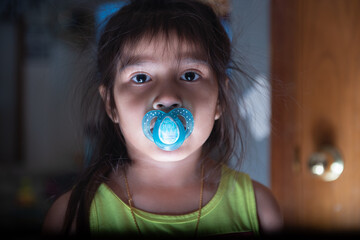 baby with a pacifier creepy