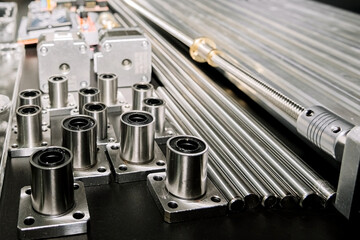 a set of parts for a laser machine on a black background, silver backlight, flat lay arduino board for controlling the machine and v slot aluminum profile lies .