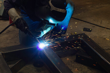 Metal workers use manual labor. Skilled welder.  Welder is welding the steel in the factory. welder Industrial automotive part in factory.