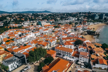 Fototapeta na wymiar Top view of the city, narrow streets and roofs of houses with red tiles Cascais.