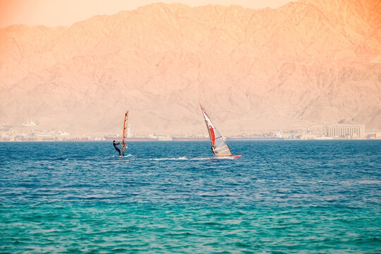 .Kite Surfing and Windsurfing in Eilat. Azure sea against the background of mountains, Khamsin in Israel..