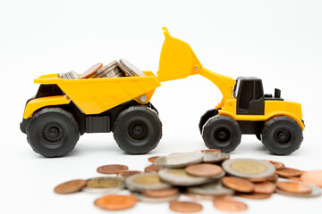 Model loader, Dump truck, coins stack on white background  for money saving concept