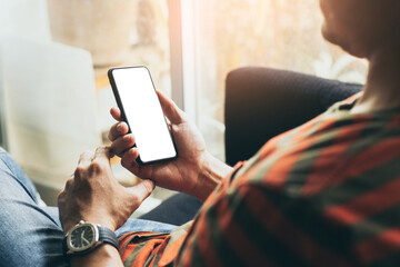 cell phone mockup blank white screen.man hand holding texting using mobile on desk at coffee shop.background empty space for advertise.work people contact marketing business,technology