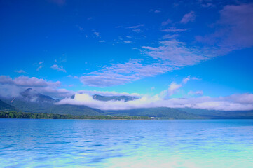 深い青空の下の湖。屈斜路湖、北海道。
Scenic landscape of mountain lake under deep blue sky. Lake Kussharo, Hokkaido, Japan.
