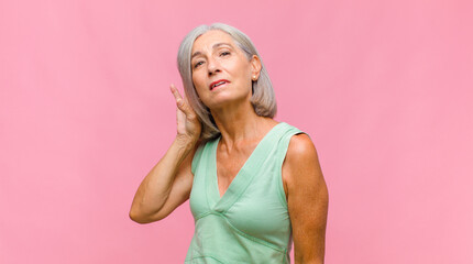 middle age pretty woman feeling confused, clueless and unsure, weighting the good and bad in...