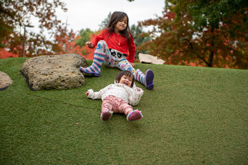 sisters playing on the park having fun 
