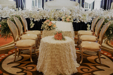 Declaration and promise wedding ceremony stage decoration with chairs and flower bouquet on it.