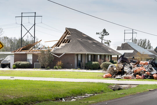 Lake Charles, Louisiana. USA - September 6, 2020:  Hurricane Laura. The destruction of the roof of a new house by a strong wind and a mountain of debris near the road