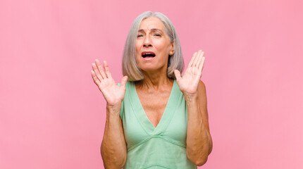 middle age pretty woman laughing and slapping forehead like saying d‚Äôoh! I forgot or that was...