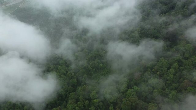 Clouds over mountains and lush tropical jungle in Asia, Laos, Khammouane, towards Thakek, on a cloudy day.