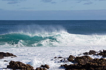 Huge  frothy waves of the Indian Ocean rolling in at famous Yallingup Beach,South Western Australia a world famous surfing mecca, on a cold yet sunny late winter morning.