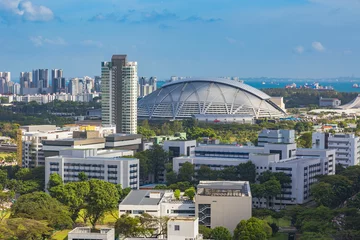 Tuinposter view of the Singapore Sports Hub with residential areas and the sea in the background © vasilevich