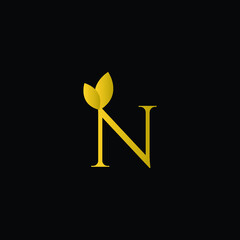 Initial Letter N Flourishes logo monogram in gold color and black background.