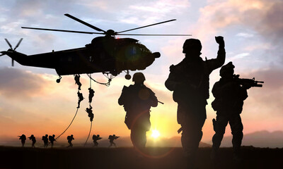 Naklejka na ściany i meble silhouette of military operation at sunset
