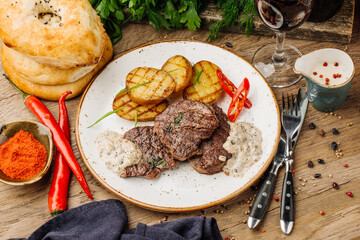 Juicy meat with spices on plate, close-up. Selective focus.