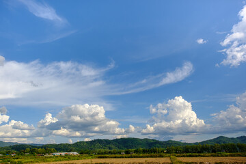 The white clouds have a strange shape and moutain.The sky and the open space have mountains below.Clouds floating above the mountains.