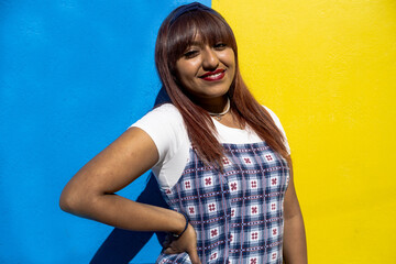 a girl posing with the blue and yellow background