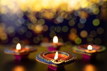 Indian festival Diwali, Diya oil lamps lit on colorful rangoli. Hindu traditional. Happy Deepavali. Copy space for text.