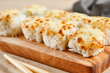 Baked shrimp rolls on wooden board top view